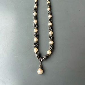 Metal and white bead necklace.